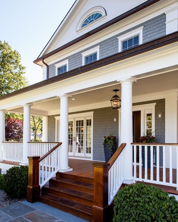 a house with white pillars and wooden steps