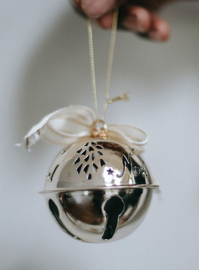 a silver ornament hanging from a string