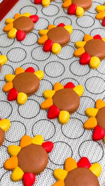 decorated cookies on a baking sheet ready to be cut into turkeys and candy cornucons