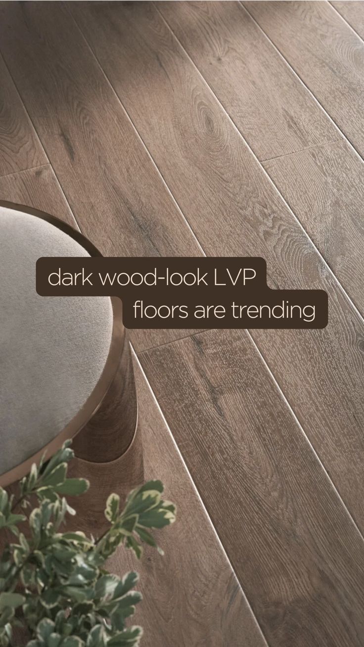 a wooden floor with text that reads dark wood look lvp floors are trending