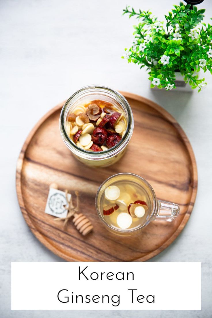 korean ginseng tea on a wooden tray next to a potted plant