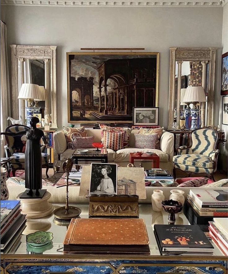 a living room filled with lots of furniture and books on top of a coffee table