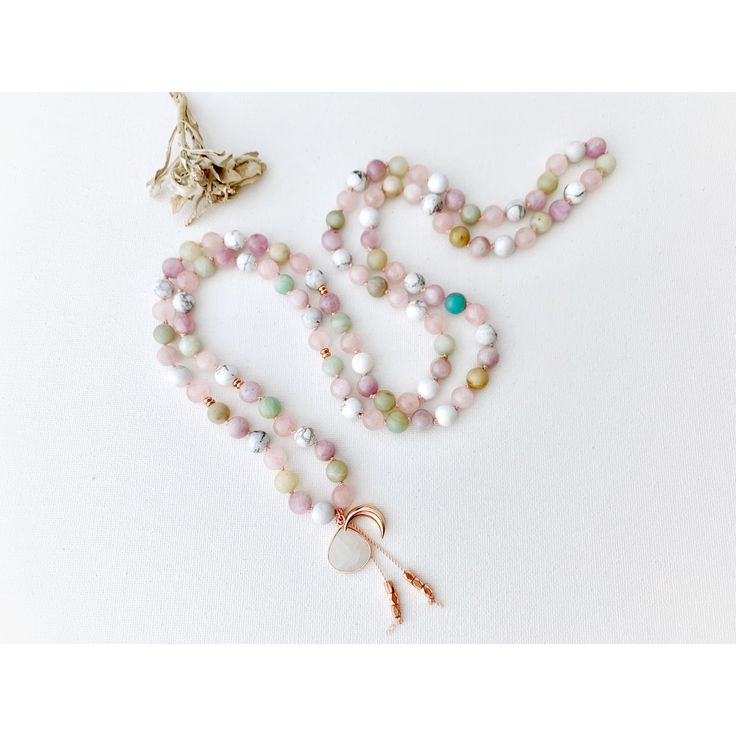 This dreamy mala necklace is filled with airy pastel colors and beautiful light energy. This 108 mala necklace is composed of Amazonite, Rose Quartz, Kunzite, Howlite and a Rainbow Moonstone Guru Crystal. Strung on a pink silk cord with Rose Gold Accents giving it a touch of tenderness and ooze with feminine energy. All Malas are saged to cleanse the energy before they are shipped to their new home. G E M S T O N E P R O P E R T I E S ♥ KUNZITE is a powerful healer of the emotional body, particu Spiritual Pink Beaded Necklaces With Natural Stones, Rose Gold Accents, Emotional Body, Light Energy, Silk Cord, Mala Necklace, Moon Goddess, Pure Joy, Mala Beads