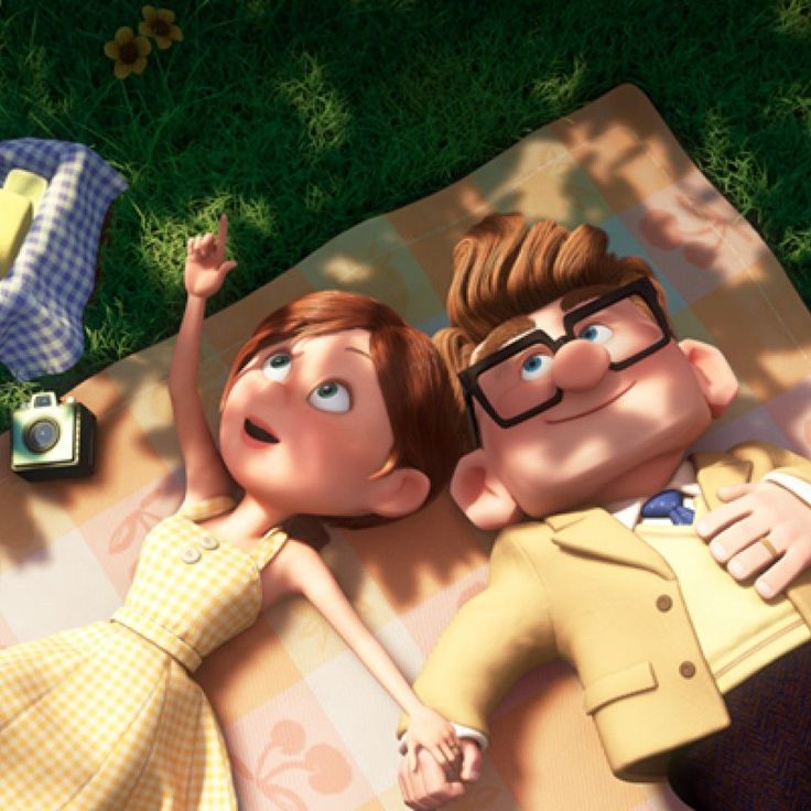 an animated image of two people laying on a blanket in the grass with their arms around each other