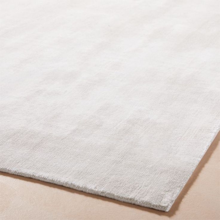 a plain white rug on the floor