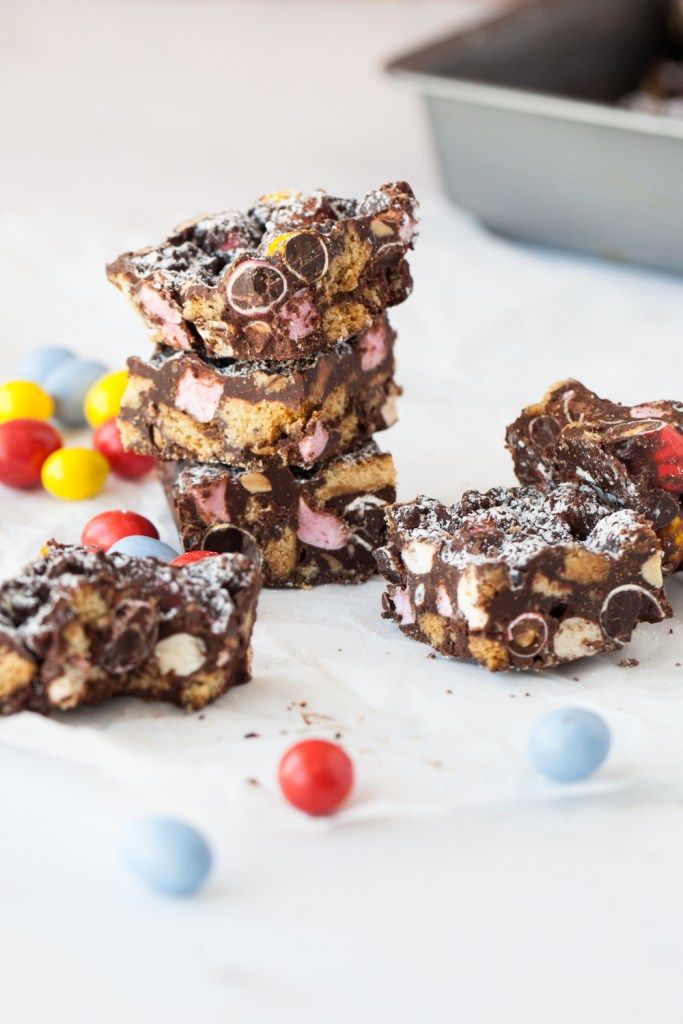 several pieces of chocolate rocky candy bars stacked on top of each other with m & m candies around them