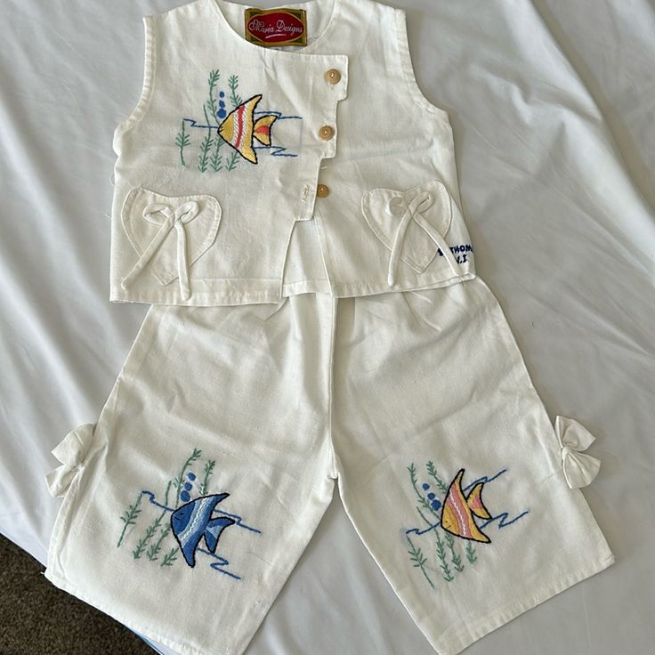 Original Handmade Piece From St. Thomas, Virgin Islands Linen Two Piece Set With Fish Embroidery Says Size Small Likely Fits A 2t.Never Worn Embroidered Cotton Short Sleeve Sets, Embroidered Cotton Sets With Short Sleeves, Embroidered Cotton Sets For Spring, Spring Cotton Embroidered Sets, Spring Embroidered Cotton Sets, Cute Embroidered Cotton Sets, White Cotton Sets With Machine Embroidery, White Cotton Sets, White Cotton Casual Sets