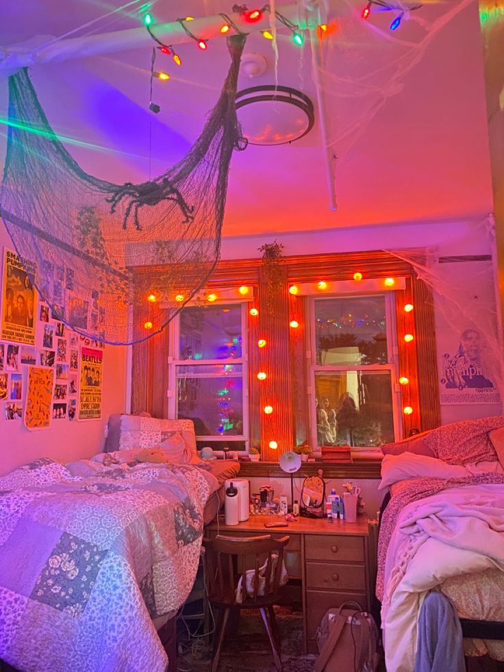 two beds in a room with lights on the ceiling