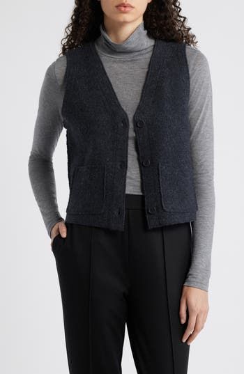 A versatile layering piece, this sculptural button-front vest is crafted from boiled wool for a soft, felted feel. 22" length Front button closure V-neck Front patch pockets 100% wool Dry clean Imported Wool Vest With Pockets For Work, Wool Vest With Button Closure For Workwear, Casual Wool Vest With Buttons, Winter Workwear Sweater Vest With Button Closure, Winter Layering Vest With Button Closure, Winter Workwear Sweater Vest With Buttons, Fall Layering Vest With Button Closure, Wool V-neck Vest For Layering, Wool Sweater Vest For Layering