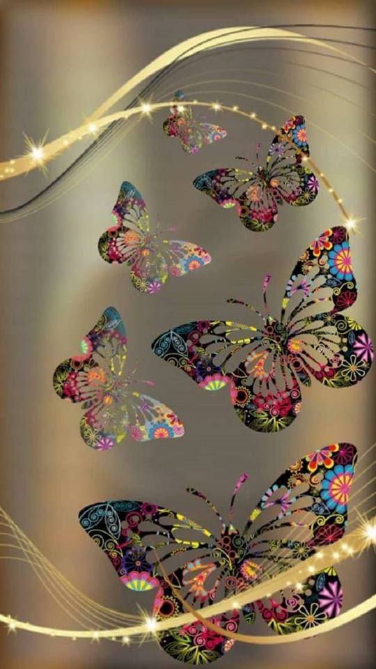 a group of butterflies flying through the air with sparkles in the sky behind them