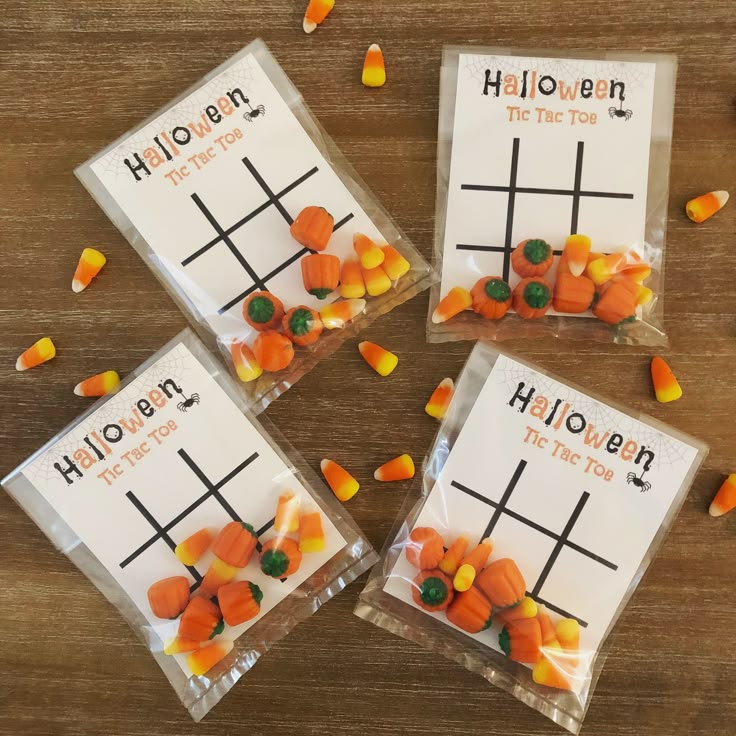 four halloween tic - tac - toe game bags with candy corn on them