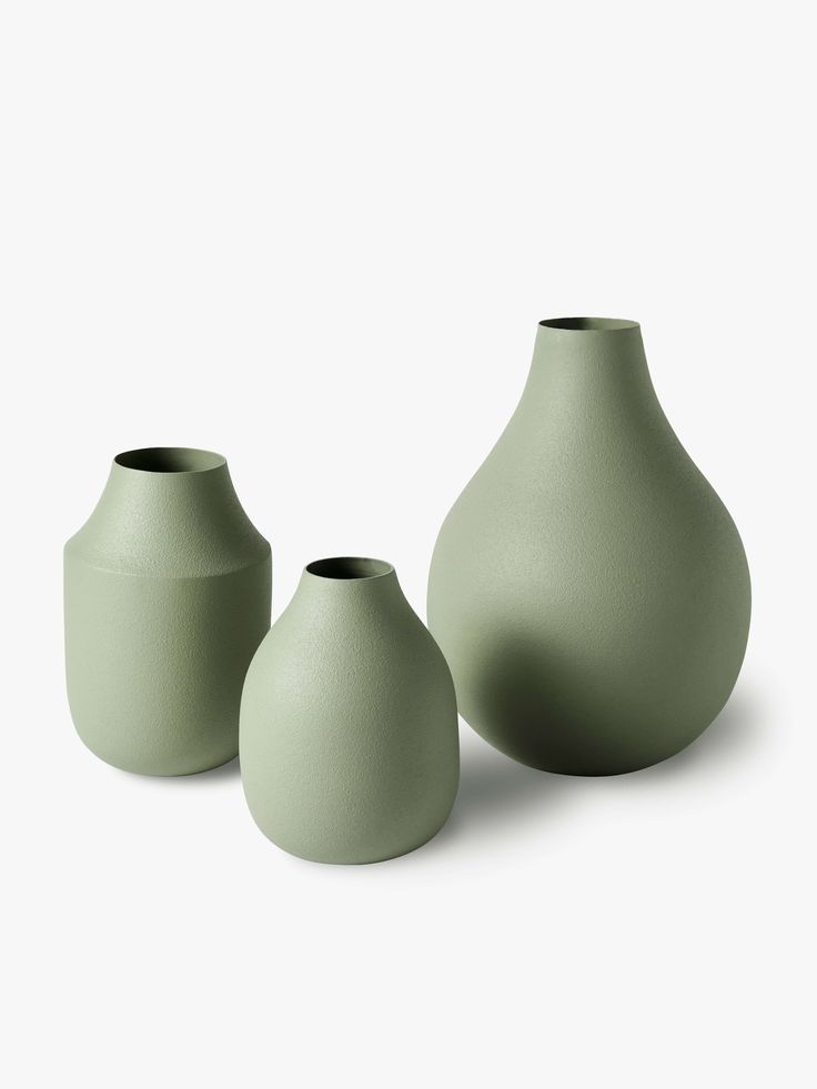 three green vases sitting next to each other