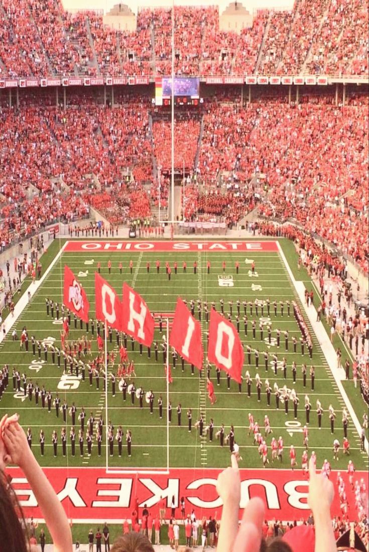 a football stadium filled with fans and cheerleaders