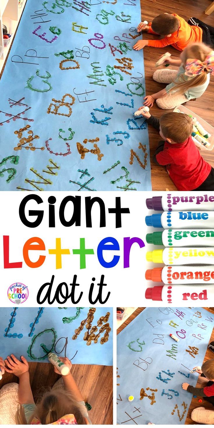 two children are playing with letters and numbers on a blue mat that says giant letter do it