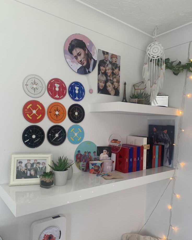 a white shelf topped with lots of different clocks