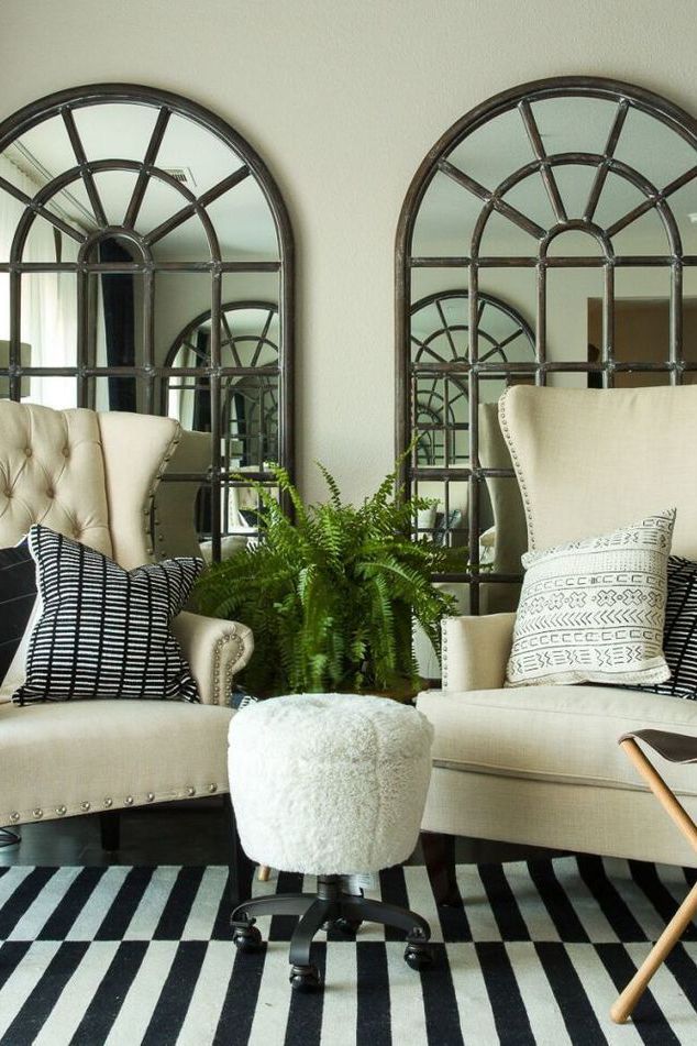 a living room filled with furniture and mirrors