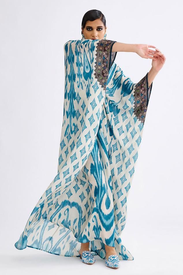 Aqua silk kaftan with diamond print and crystal embellished waistband in centre.
Components: 1
Pattern: Printed, Emellished
Type Of Work: Diamond, crystal
Neckline: V neck
Sleeve Type: Kaftan sleeves
Fabric: Silk
Color: Blue
Other Details: 
Front embellished waistband
Note: Earrings  shown in the image is not for sale
Occasion: Mehendi and Haldi - Aza Fashions Blue Silk Kaftan For Vacation, Blue Silk Kaftan For Beach Cover-up, Blue Silk Bohemian Maxi Dress, Bohemian Blue Silk Maxi Dress, Silk Kaftan With Embellished Kimono Sleeves, Embellished Silk Kaftan With Kimono Sleeves, Blue Silk Kaftan For Festival, Embellished Silk Kaftan For The Beach, Elegant Silk Kaftan For Beach Cover-up