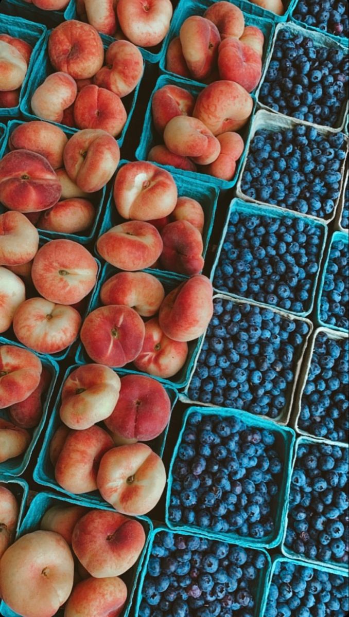 blueberries and peaches are on display for sale