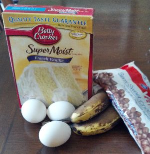 eggs, bananas, and other ingredients are on a table next to a package of crackers