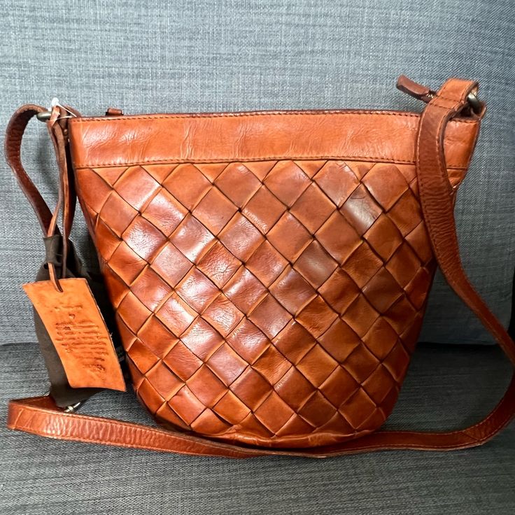 Brand New With Tag Hard To Find Vilenca Holland Crossbody Shoulder Bag Clutch Soft Genuine Leather Cognac Color Weaved On The Front Old Brass Hardware Long Adjustable Strap Zipper Closure On The Top Lined Interior: One Zipper Pocket Two Slip Pockets Approximately 11”L * 9.5”H * 4.5"W Gorgeous Durable Bag Made In Holland Pet & Smoke Free Home Please See My Entire Collection Cognac Woven Leather Bag, Cognac Woven Leather Tote Shoulder Bag, Cognac Woven Leather Shoulder Bag For Everyday, Everyday Cognac Woven Leather Shoulder Bag, Cognac Leather Shoulder Bag With Woven Detail, Cognac Woven Leather Shopping Bags, Cognac Crossbody Hobo Bag, Woven Leather Pouch Shoulder Bag, Orange Crossbody Bucket Bag