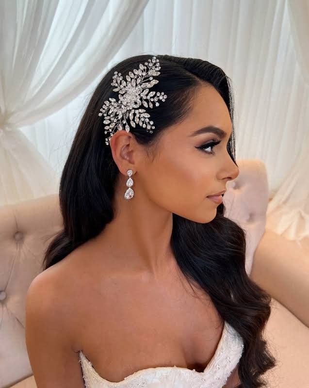 a woman in a wedding dress wearing a bridal hair comb