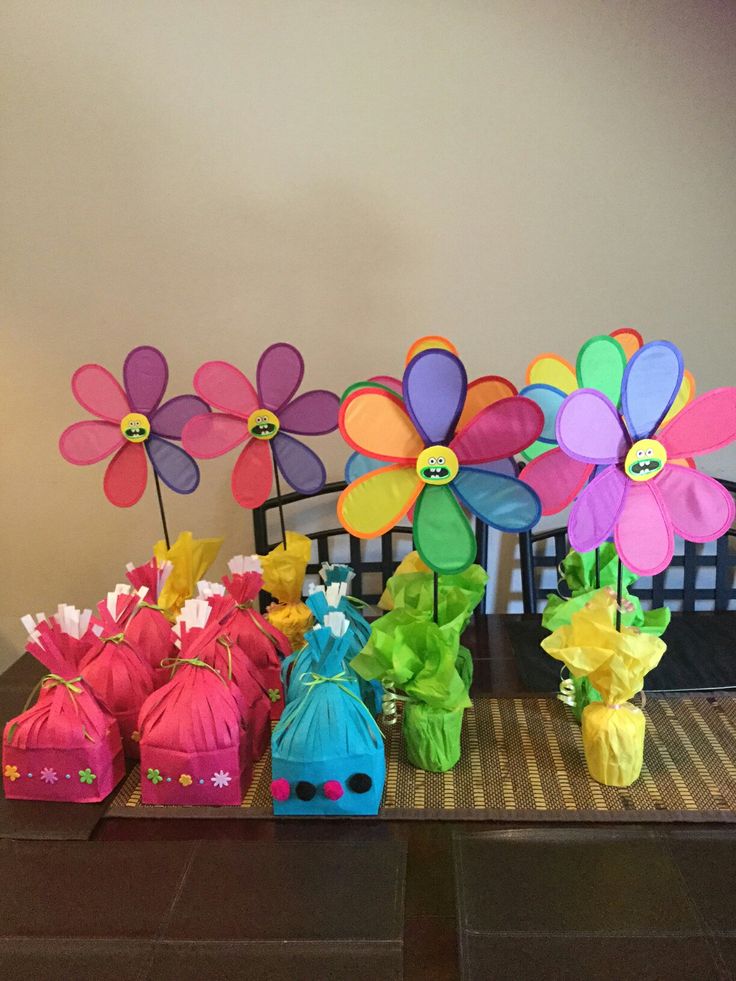 colorful paper flowers and bags on a table