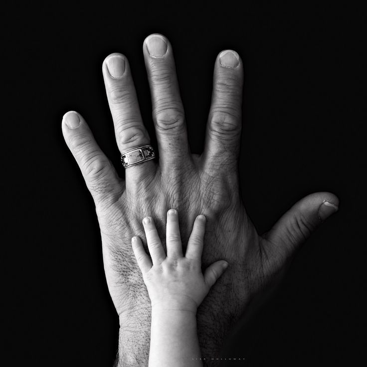 two hands reaching out to each other with the letter c on their middle finger, in front of a black background