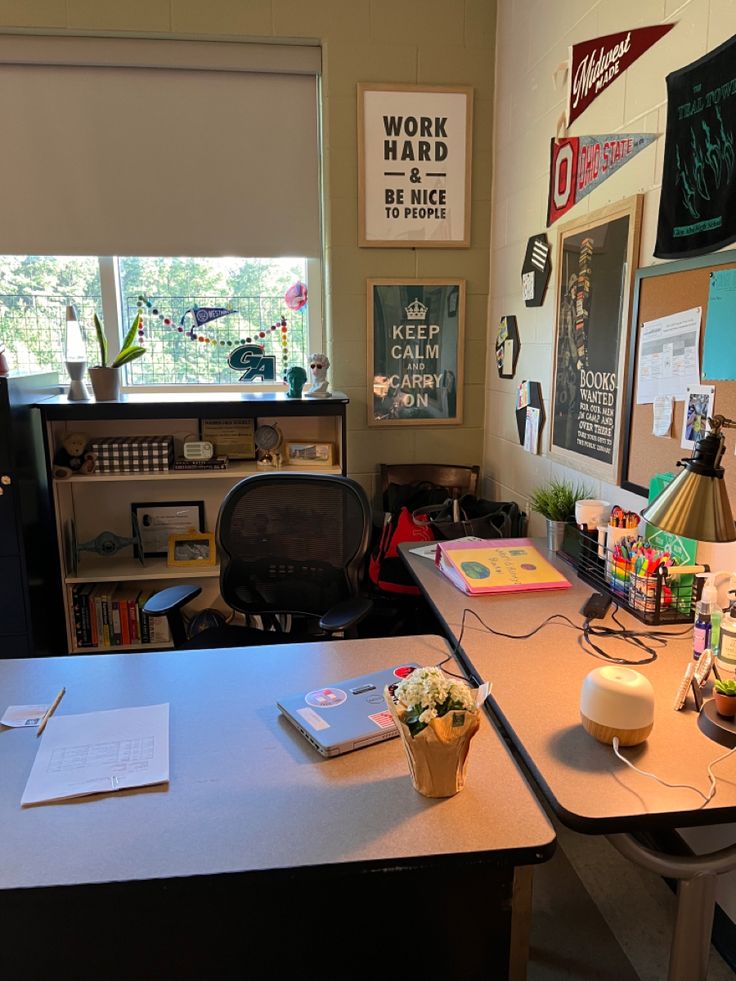 a work area with desk, computer monitor and other items on the table in front of a window