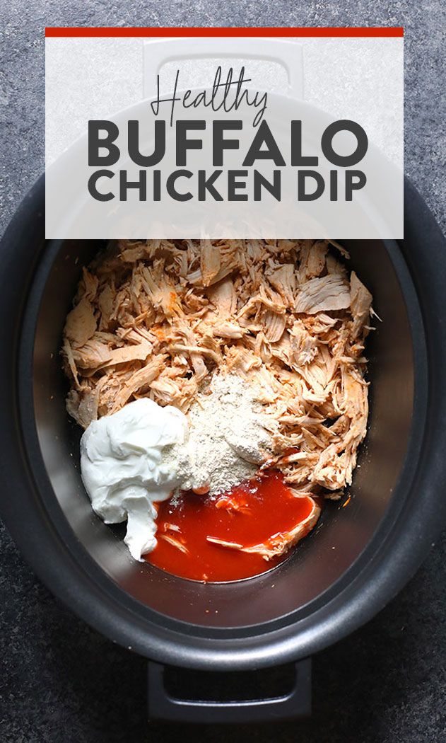 a bowl filled with meat and sauce on top of a counter next to a sign that says healthy buffalo chicken dip