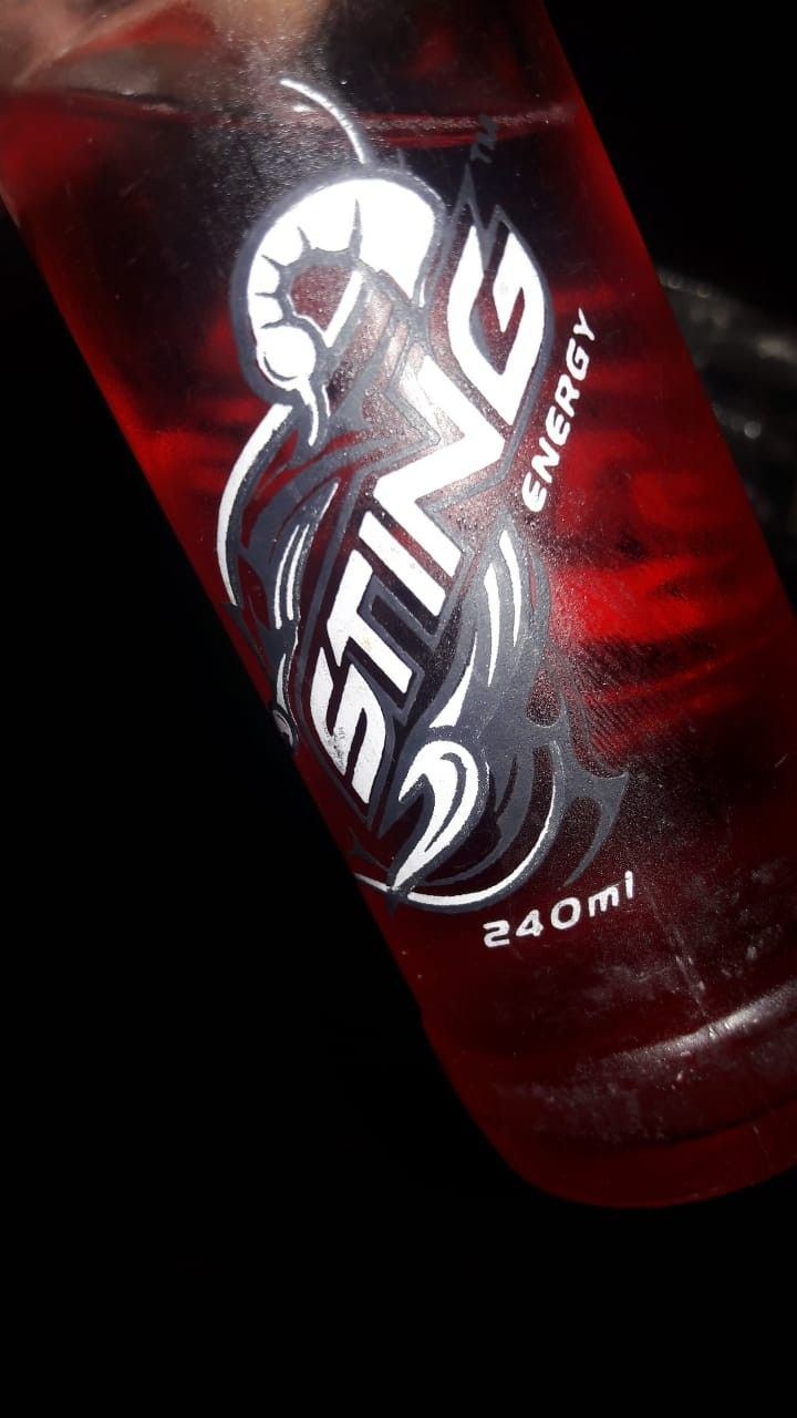 a close up of a bottle of energy drink in someone's hand with the label on it