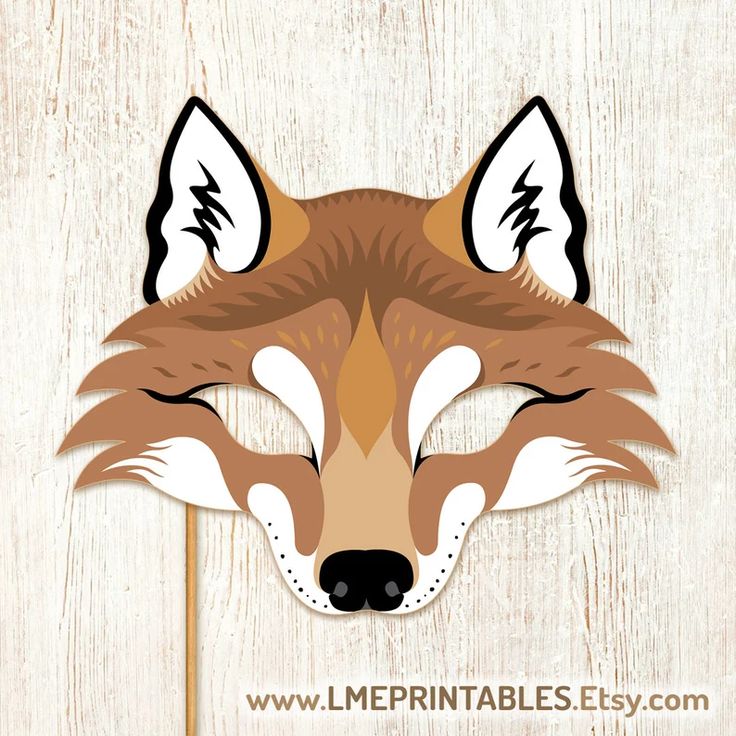 a paper fox mask on a wooden background