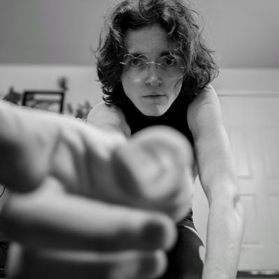 a woman in glasses is pointing at something