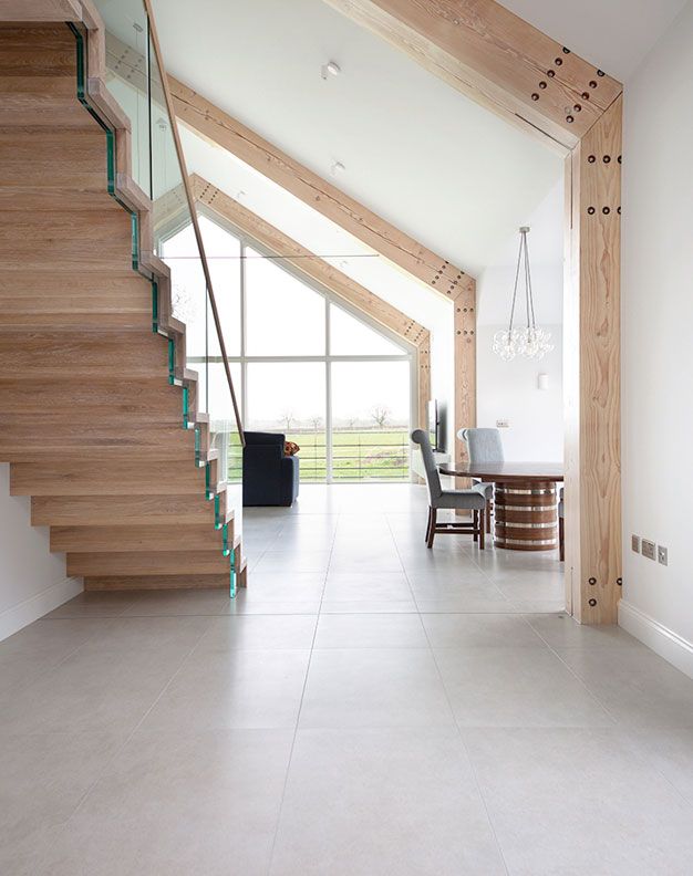 an open floor plan with stairs leading up to the dining room