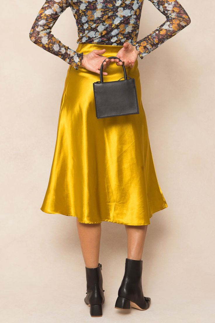 Say hello to the Tiff Skirt in Chartreuse - the perfect combination of style and comfort! This midi-length skirt made from yellow satin fabric is not only elegant but also easy to slip on. And with its stretchy material, you'll never want to take it off. A must-have for any fashion-forward wardrobe. City Woman, Take It Off, Yellow Satin, Midi Length Skirts, Satin Fabric, Say Hello, Stretchy Material, Midi Length, Ivy