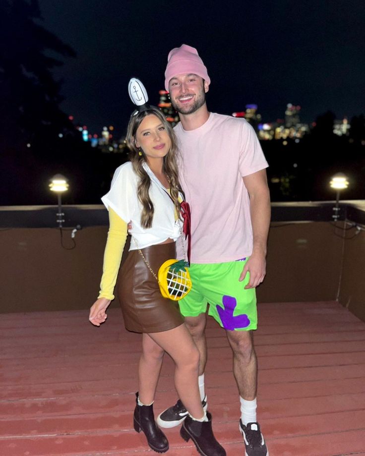 a man standing next to a woman on top of a roof