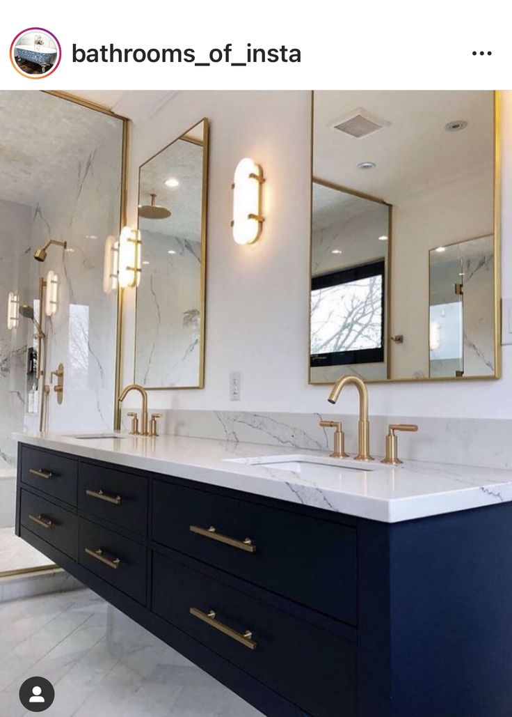 a bathroom with marble counter tops and blue cabinets