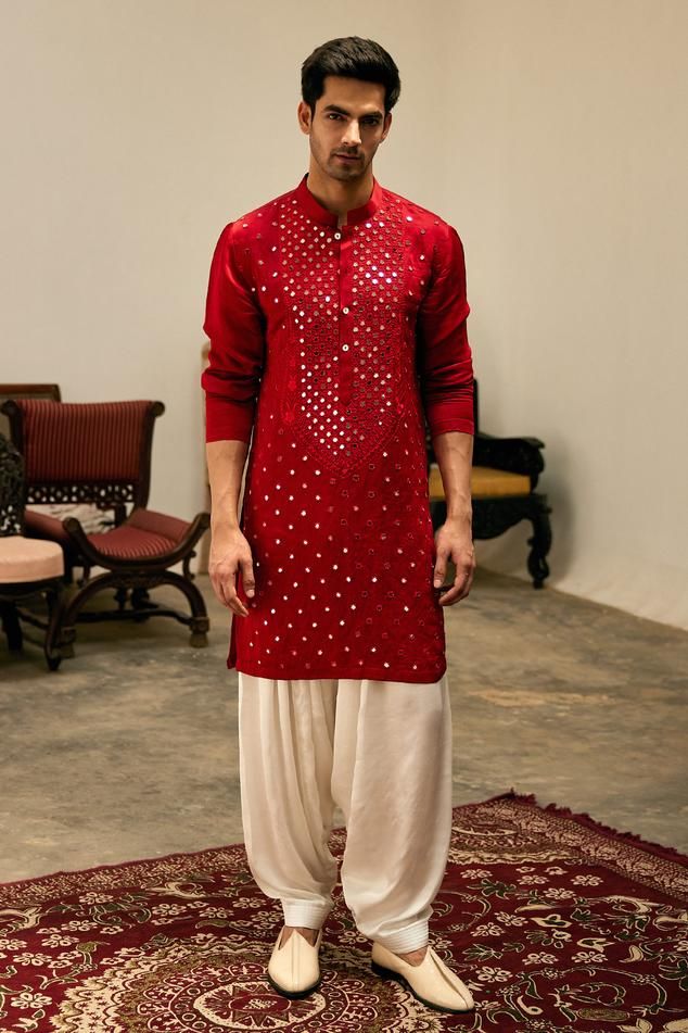 Sindoor red kurta with thread, mirror embroidery in geometric pattern and mandarin collared neckline. Paired with salwar.
Components: 2
Pattern: Embroidery
Type Of Work: Mirror, thread
Neckline: Mandarin collar
Sleeve Type: Full sleeves
Fabric: Linen Cotton Silk
Color: Red
Other Details: 
Front button detailing
Side slit kurta
Occasion: Sangeet - Aza Fashions Sufi Night Outfit For Men, Red Kurta Men, Red Kurta For Men, Stylish Kurta For Men, Sufi Night, Indian Menswear, Mirror Work Kurta, Mehendi Night, Indian Wedding Clothes For Men