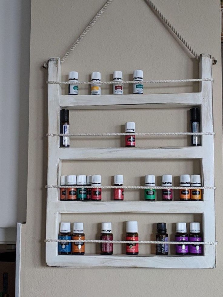 an old ladder is used as a spice rack to display essential oils and other spices