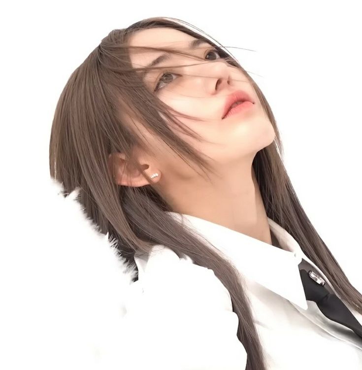 a woman with long brown hair wearing a white shirt and black tie, looking up at the sky