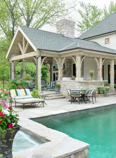 an outdoor pool and patio with seating area