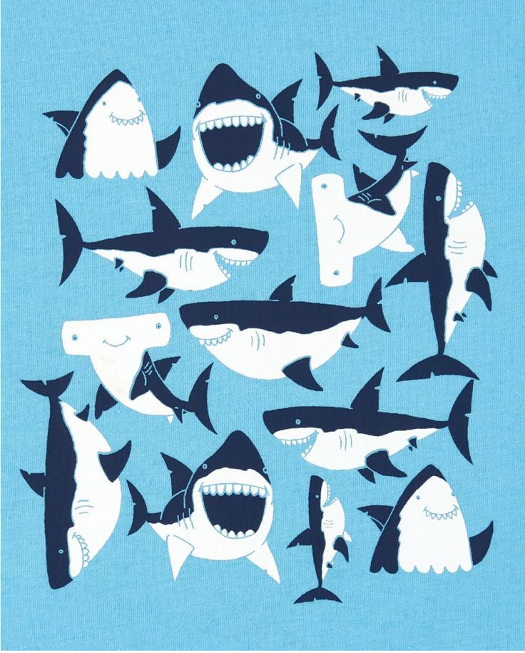 a bunch of sharks that are in the ocean together on a blue shirt with white teeth