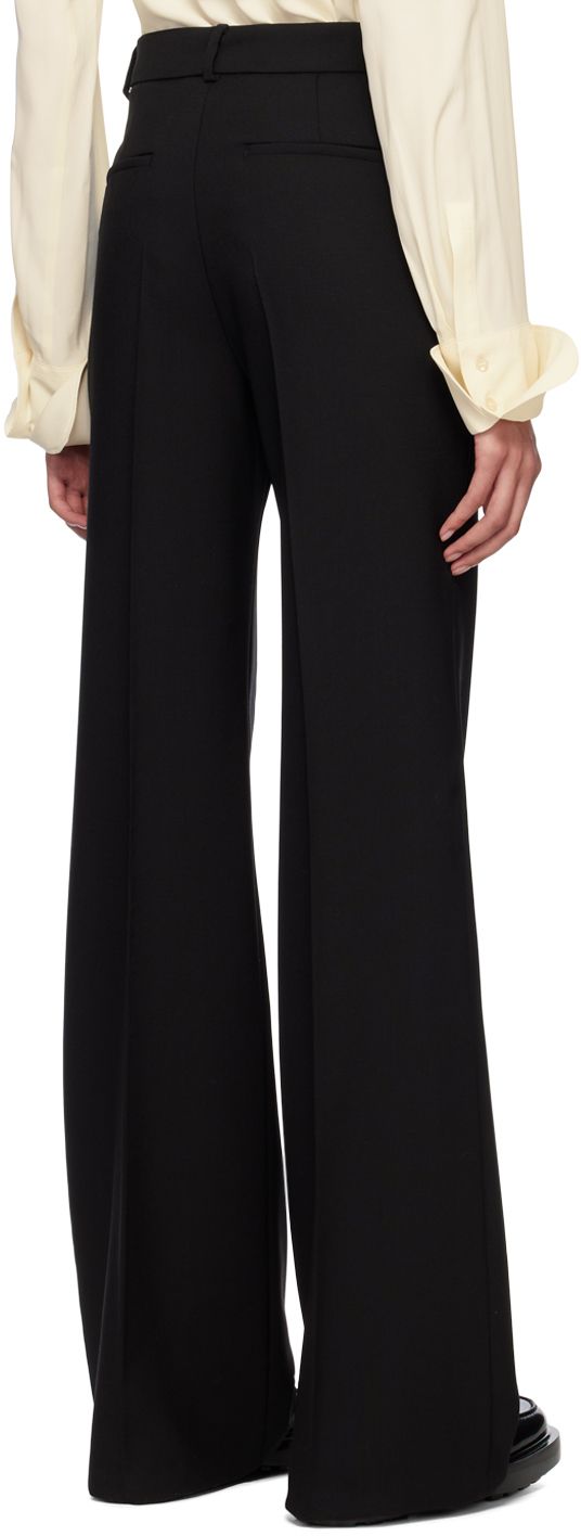 Virgin wool canvas trousers. · Belt loops · Four-pocket styling · Zip closure · Creased legs · Flared cuffs · Unfinished hem Supplier color: Black Formal Pants With Button Cuffs For Fall, Elegant Formal Pants With Flared Cuffs, Fitted Bottoms With Flared Cuffs For Work, Formal High-waisted Pants With Button Cuffs, Black Flared Trousers, Flared Trousers, Black Flare, Flare Trousers, Luxury Streetwear