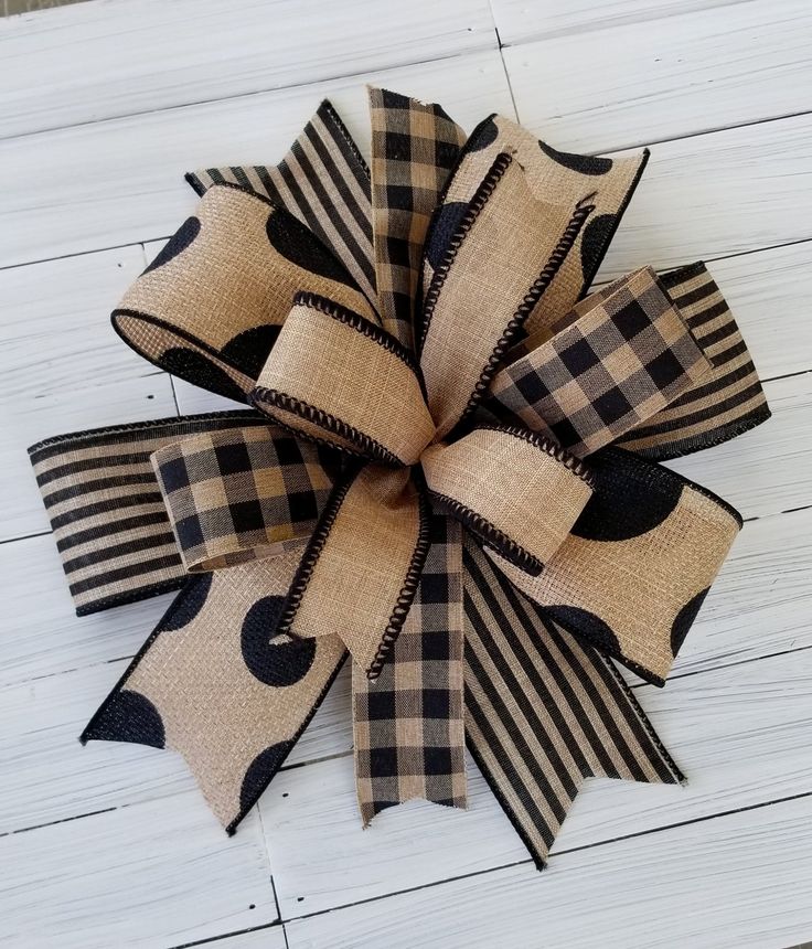 a burlocked bow with black and white checkered ribbon on a wooden surface