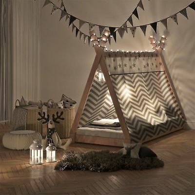 a bedroom with a teepee bed and pillows on the floor