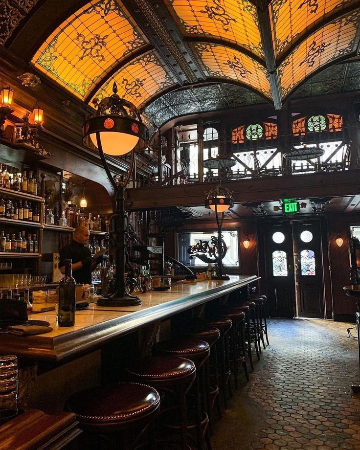 the interior of a bar with stained glass windows