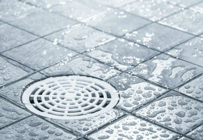 a shower floor with water drops on it and the words cleaning stains on a shower floor