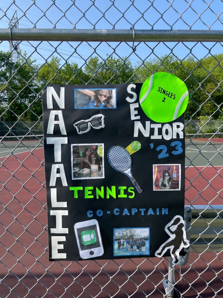 a sign on a fence with tennis related items