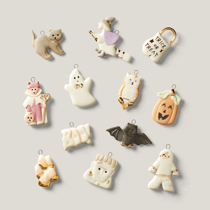 a group of ceramic ornaments that are shaped like animals and bats with words written on them