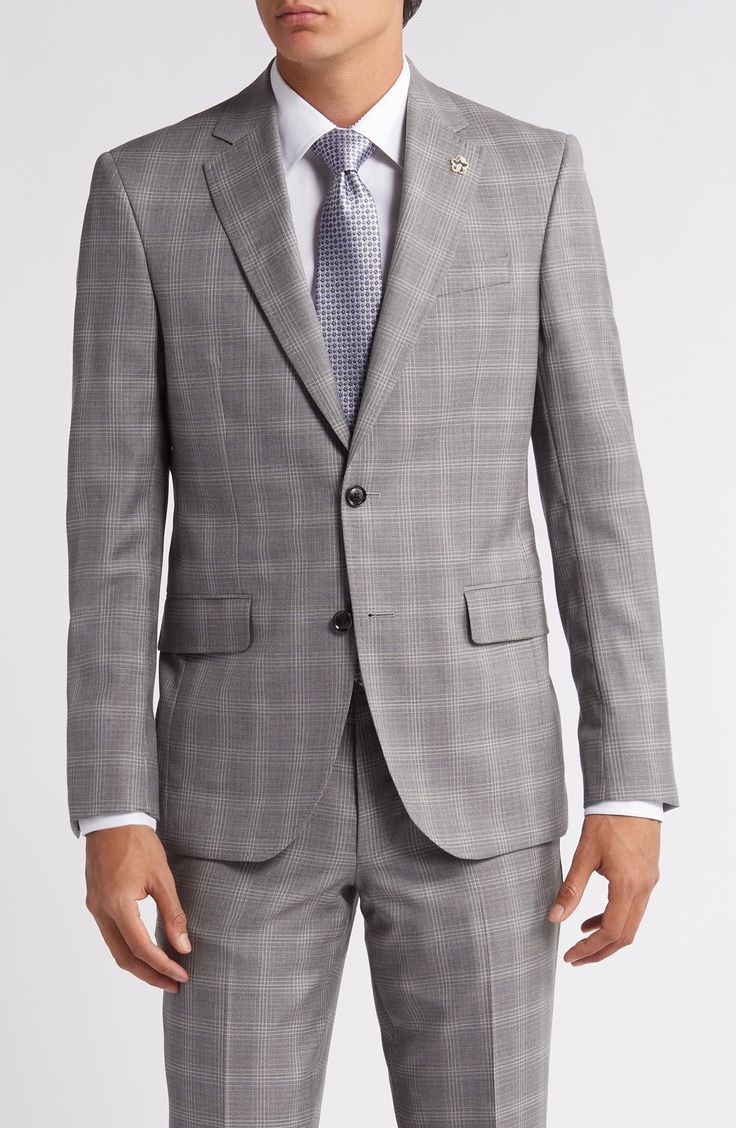 Grey Italian wool woven in a chalky plaid distinguishes a suit that's styled with traditional detailing to make it a smart addition to any formal wardrobe. Jacket has notched lapels; four-button cuffs; chest pocket; flap pockets; side vents Trousers have zip fly with button-tab closure; slant pockets; back button-welt pockets Jacket is lined Unhemmed 100% wool Dry clean Made in Canada Formal Plaid Blazer With Hidden Button Closure, Formal Plaid Blazer With Hidden Buttons, Classic Formal Plaid Blazer, Classic Plaid Blazer For Formal Occasions, Formal Plaid Tweed Jacket With Notch Lapel, Formal Plaid Pattern Tweed Jacket With Notch Lapel, Timeless Plaid Formal Outerwear, Elegant Plaid Sport Coat With Suit Collar, Elegant Plaid Sport Coat For Business