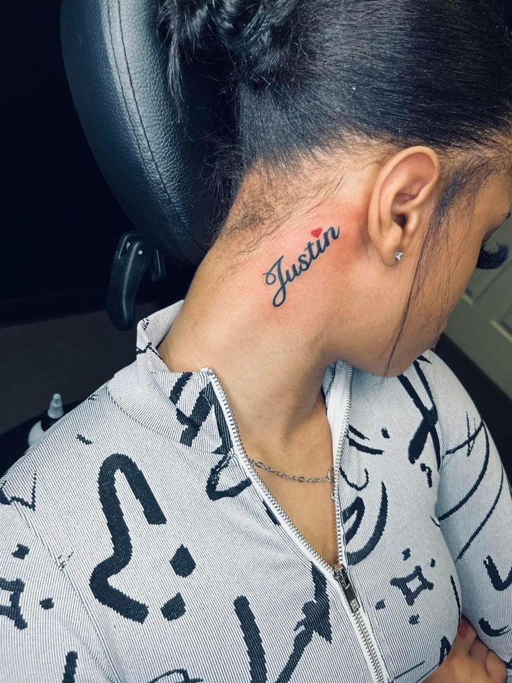 a woman with a tattoo on her neck